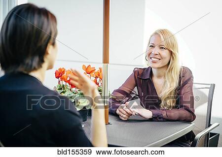 Businesswomen having lunch in cafe View Large Photo Image Stock Photo - Businesswomen having lunch in cafe. Fotosearch