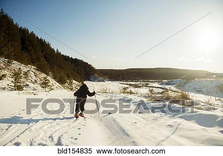 Stock Photography - Caucasian boy cross-country skiing in snowy field. Fotosearch