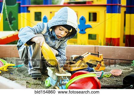 Caucasian boy playing in sandbox View Large Photo Image Stock Image - Caucasian boy playing in sandbox. Fotosearch