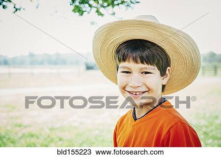 Stock Image - Caucasian boy smiling on farm. Fotosearch