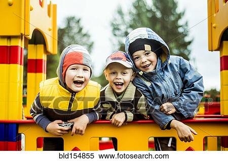 Stock Photography - Caucasian boys smiling at playground. Fotosearch