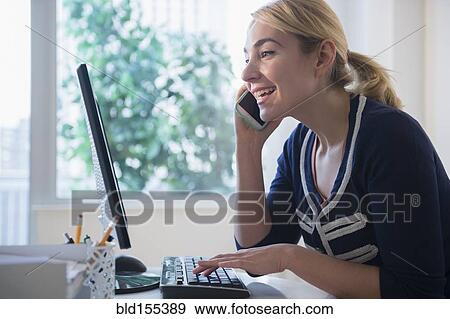 Caucasian businesswoman multi-tasking at desk View Large Photo Image Stock Photo - Caucasian businesswoman multi-tasking at desk. Fotosearch