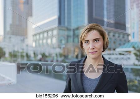 Stock Photograph - Caucasian businesswoman standing in city. Fotosearch