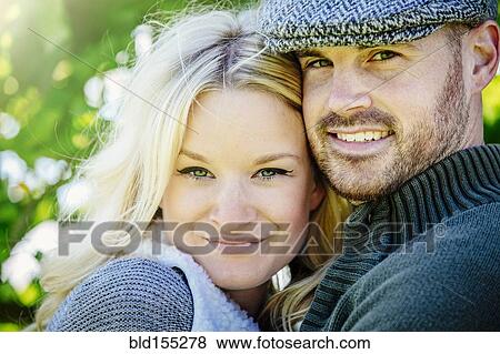Stock Photo - Caucasian couple hugging outdoors. Fotosearch