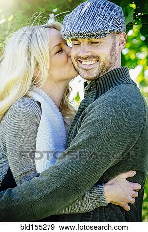 Caucasian couple kissing outdoors View Large Photo Image Stock Photo - Caucasian couple kissing outdoors. Fotosearch