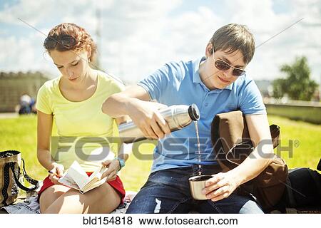 Stock Photo - Caucasian couple relaxing in park. Fotosearch