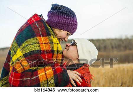 Caucasian couple wrapped in blankets outdoors View Large Photo Image Stock Photograph - Caucasian couple wrapped in blankets outdoors. Fotosearch