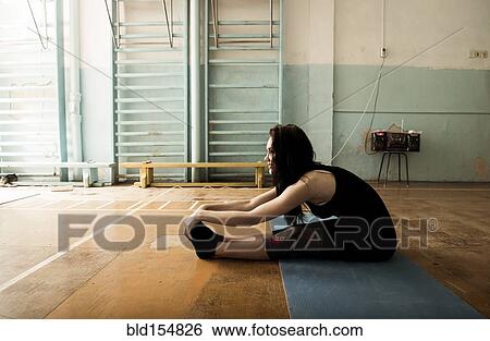 Caucasian dancer stretching in gym View Large Photo Image Stock Photograph - Caucasian dancer stretching in gym. Fotosearch