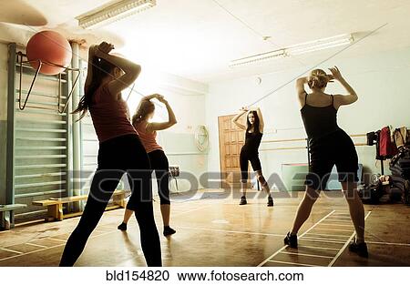 Stock Image - Caucasian dancers rehearsing in gym. Fotosearch