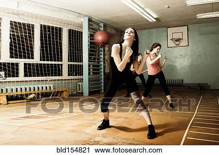 Stock Image - Caucasian dancers rehearsing in gym. Fotosearch