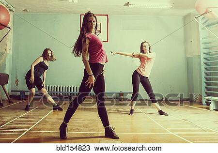 Stock Image - Caucasian dancers rehearsing in gym. Fotosearch
