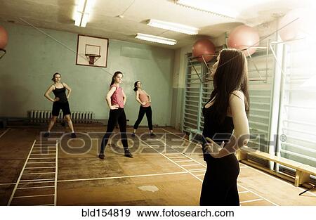 Stock Photo - Caucasian dancers rehearsing in gym. Fotosearch