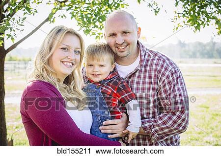 Caucasian family smiling on farm View Large Photo Image Stock Image - Caucasian family smiling on farm. Fotosearch