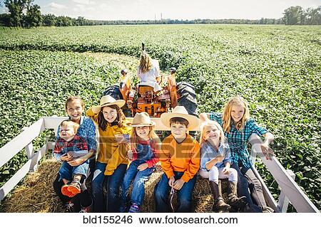 Caucasian family smiling on hay ride View Large Photo Image Stock Photograph - Caucasian family smiling on hay ride. Fotosearch