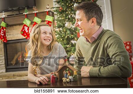 Caucasian father and daughter arranging nativity at Christmas View Large Photo Image Stock Image - Caucasian father and daughter arranging nativity at Christmas. Fotosearch