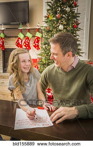 Caucasian father and daughter writing to Santa at Christmas View Large Photo Image Stock Photo - Caucasian father and daughter writing to Santa at Christmas. Fotosearch