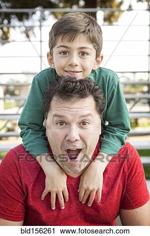 Caucasian father and son playing on bleachers View Large Photo Image Stock Image - Caucasian father and son playing on bleachers. Fotosearch