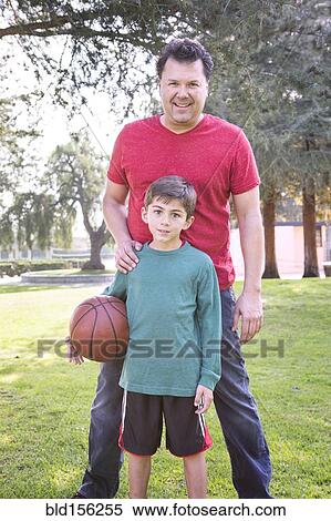Caucasian father and son smiling in park with basketball View Large Photo Image Stock Photography - Caucasian father and son smiling in park with basketball. Fotosearch