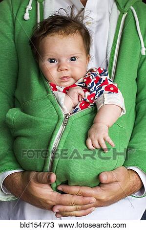 Caucasian father holding baby girl in zipped hoodie View Large Photo Image Stock Image - Caucasian father holding baby girl in zipped hoodie. Fotosearch