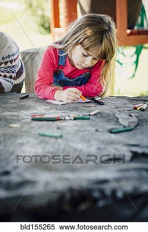 Caucasian girl coloring outdoors View Large Photo Image Stock Photography - Caucasian girl coloring outdoors. Fotosearch