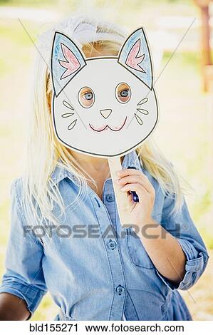 Caucasian girl holding cat mask View Large Photo Image Stock Image - Caucasian girl holding cat mask. Fotosearch
