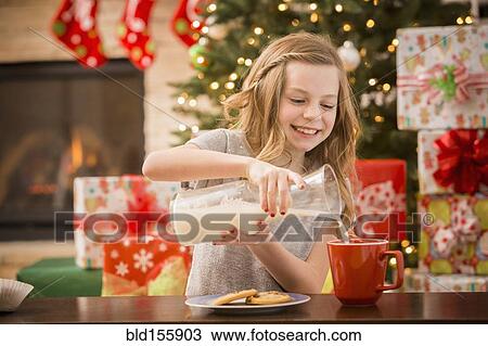 Caucasian girl leaving cookies and milk for Santa at Christmas View Large Photo Image Stock Image - Caucasian girl leaving cookies and milk for Santa at Christmas. Fotosearch