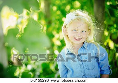 Stock Image - Caucasian girl smiling outdoors. Fotosearch
