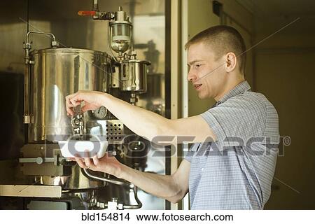 Picture - Caucasian man pouring hot water into bowl. Fotosearch