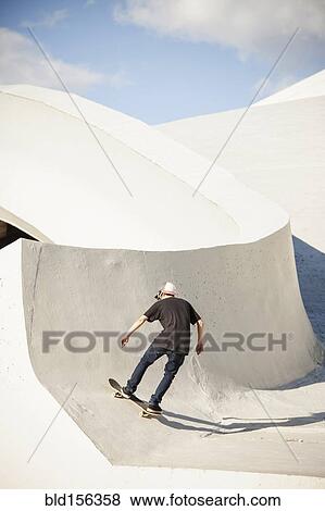 Caucasian man skating at skate park View Large Photo Image Stock Photo - Caucasian man skating at skate park. Fotosearch