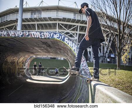 Caucasian man skating on half pipe at skate park View Large Photo Image Stock Photo - Caucasian man skating on half pipe at skate park. Fotosearch