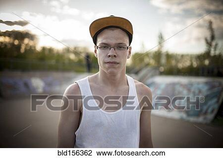 Caucasian man standing at skate park View Large Photo Image Stock Image - Caucasian man standing at skate park. Fotosearch