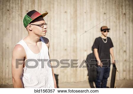 Caucasian men with skateboards near wooden wall View Large Photo Image Stock Photo - Caucasian men with skateboards near wooden wall. Fotosearch