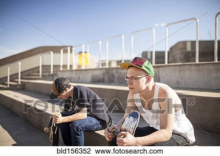 Caucasian men with skateboards sitting on steps View Large Photo Image Stock Image - Caucasian men with skateboards sitting on steps. Fotosearch