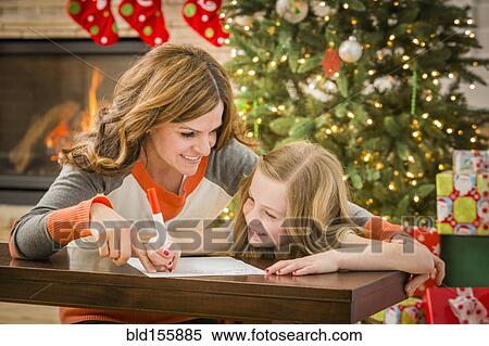 Caucasian mother and daughter writing to Santa at Christmas View Large Photo Image Stock Photography - Caucasian mother and daughter writing to Santa at Christmas. Fotosearch