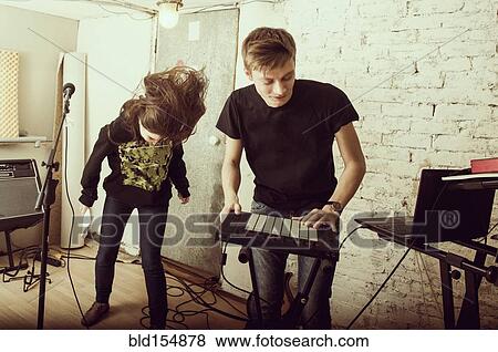Caucasian musicians playing in rock band View Large Photo Image Stock Photo - Caucasian musicians playing in rock band. Fotosearch
