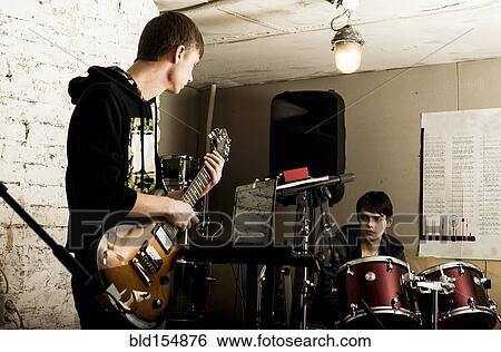 Caucasian musicians playing in rock band View Large Photo Image Stock Photograph - Caucasian musicians playing in rock band. Fotosearch