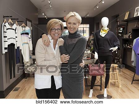 Caucasian small business owners working in clothing store View Large Photo Image Stock Image - Caucasian small business owners working in clothing store. Fotosearch