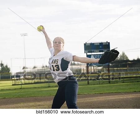 Caucasian softball player pitching ball in field View Large Photo Image Stock Image - Caucasian softball player pitching ball in field. Fotosearch