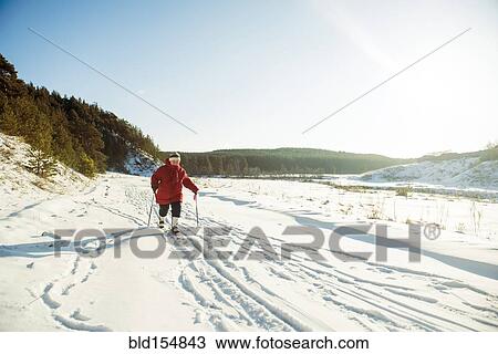 Caucasian woman cross-country skiing in snowy field View Large Photo Image Stock Image - Caucasian woman cross-country skiing in snowy field. Fotosearch