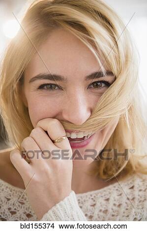 Caucasian woman playing with hair View Large Photo Image Picture - Caucasian woman playing with hair. Fotosearch