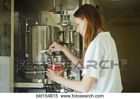 Stock Photography - Caucasian woman pouring hot water into bowl. Fotosearch