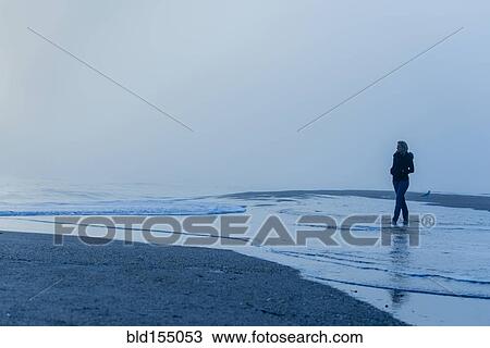 Caucasian woman walking in waves on beach View Large Photo Image Stock Image - Caucasian woman walking in waves on beach. Fotosearch
