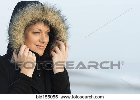 Caucasian woman wearing coat with fur hood outdoors View Large Photo Image Stock Photography - Caucasian woman wearing coat with fur hood outdoors. Fotosearch