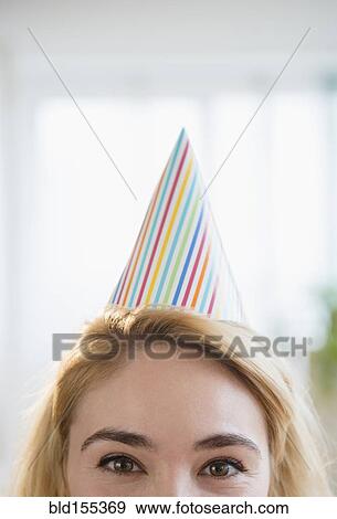 Stock Photo - Caucasian woman wearing party hat. Fotosearch