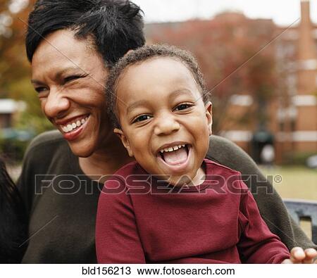 Close up of African American mother and son laughing View Large Photo Image Stock Image - Close up of African American mother and son laughing. Fotosearch