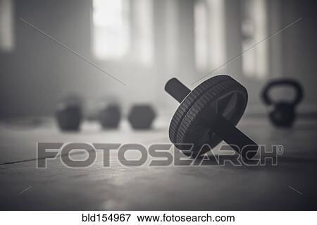 Close up of barbell weights on floor of dark gym View Large Photo Image Stock Photo - Close up of barbell weights on floor of dark gym. Fotosearch