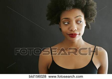 Stock Photo - Close up of black woman smirking. Fotosearch