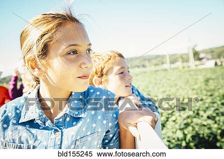 Stock Photography - Close up of Caucasian brother and sister admiring farm. Fotosearch