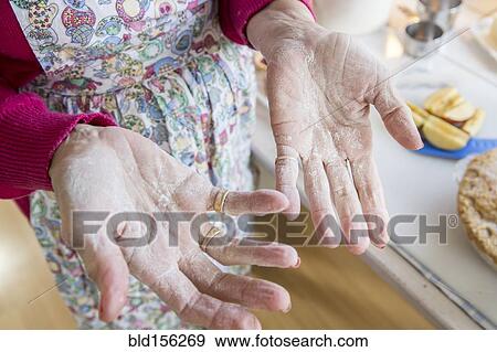 Stock Photo - Close up of flour on hands of older Caucasian woman. Fotosearch