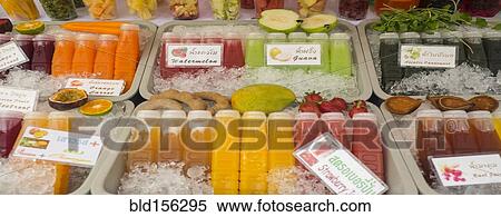 Stock Photography - Close up of fresh juices for sale in market. Fotosearch